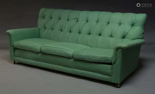 A three seater sofa, late 20th Century, upholstered in green button back fabric, with three loose