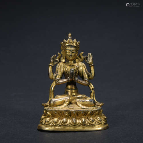 A gilt-bronze statue of Four-armed Guan Yin