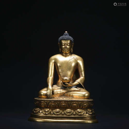 A gilt-bronze statue of Medicine Buddha