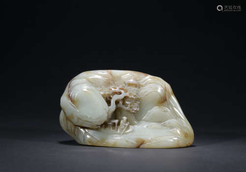 A jade ornament with figure and mountain pattern