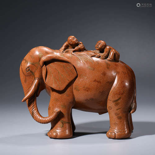 AN CHINESE SANDSTONE ELEPHANT AND TWO CHILDREN