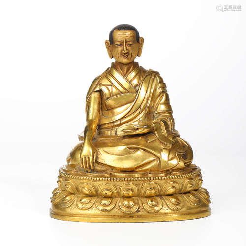 A CHINESE GILT-BRONZE GURU STATUE