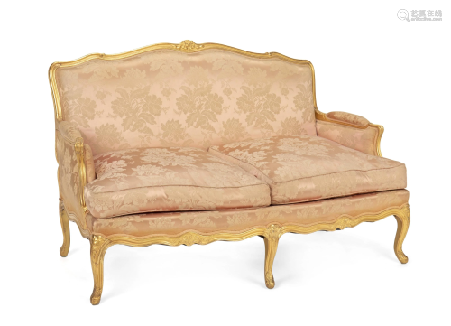 A French Louis XV-style giltwood settee with pink
