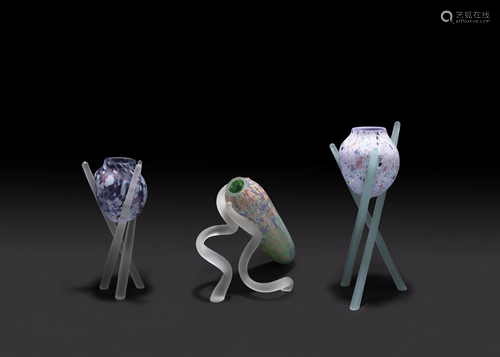 Three multicolor glass vases on pedestals