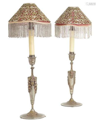 A pair of spelter candlesticks with shades