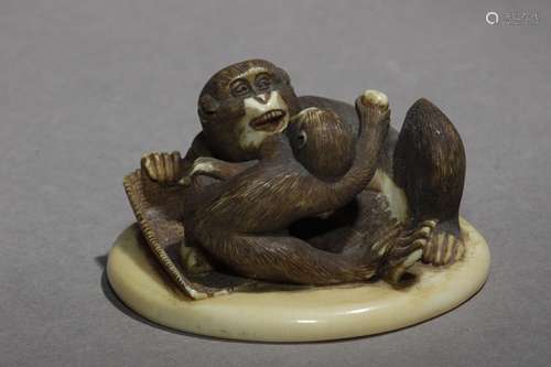 Netsuke-okimono finales siglo XIX.明治时期。坚定的清国，在一个汉字的纳卡的基础上。在圆形的基座上有两个单字，代表两个单字，其中有一个圆形的基座。El pequeño está comiendo unos frutos, 28,70x50,40x53,30 mm.44 gr. Publicado en Mateu Guillermo.