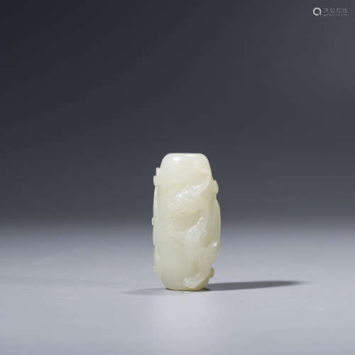 A CHINESE WHITE JADE CHI DRAGON ORNAMENT