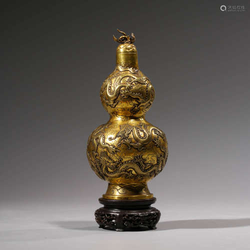 A CHINESE GILT-BRONZE NINE DRAGONS DOUBLE-GOURD VASE AND STAND