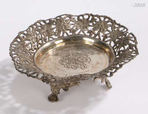 Eastern white metal dish, wih pierced foliate border, raised on three scroll cast feet, 13.5cm