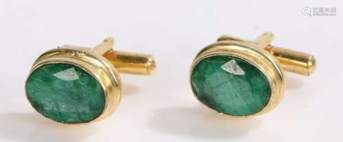 Pair of emerald and gilt metal cufflinks, with oval set heads