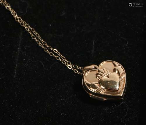 9 carat gold locket, of heart form with depiction of two hands holding a heart, on a necklace, 1.6g