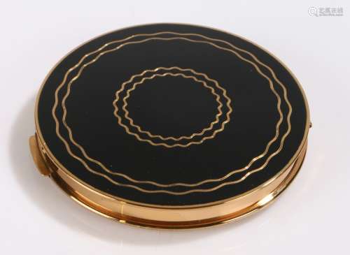 Stratton gilt metal compact, the lid with gilt wavy line decoration on a black ground, the