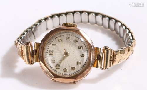 9 carat gold ladies wristwatch, the white engine turned dial with Arabic markers, manual wound,