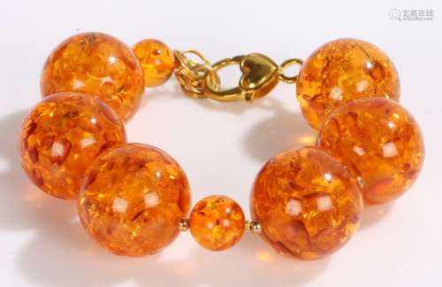 Copal amber effect bead bracelet, with gilt heart decorated clasp