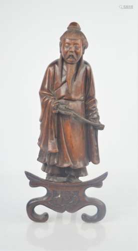 A Chinese wooden carved figure on stand. 33cm