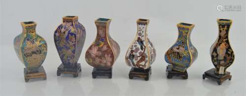 A group of miniature Chinese cloisonne vases on stands