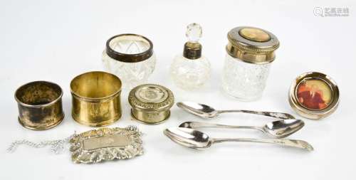 Three silver spoons, a silver napkin ring, a small circular silver photograph frame, a silver and