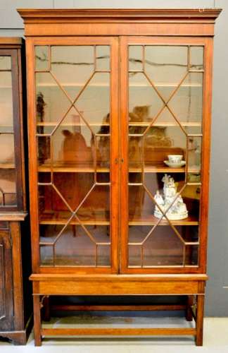 A 19th century mahogany glazed bookcase, with height adjustable shelves, raised on a base with
