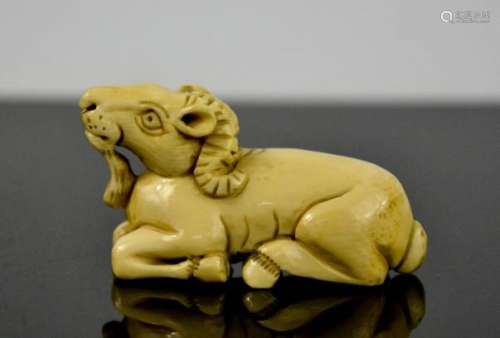 A Chinese carved ivory netsuke, in the form of a ram, signed to the base, circa 1900, 3cm high.