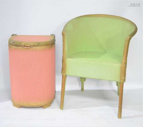 A green chair and Lloyd Loom style linen basket.