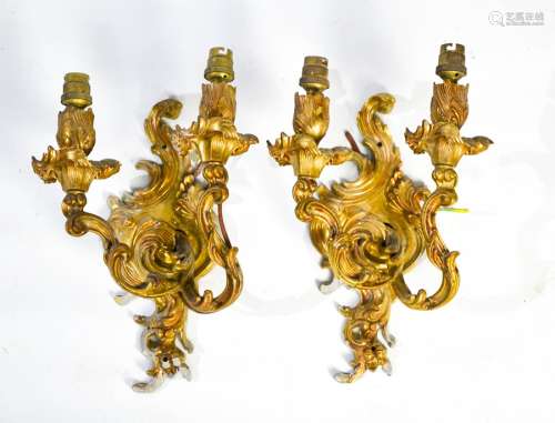 A pair of brass Rococo style wall lights both with two scrolling branches, 31cm high.