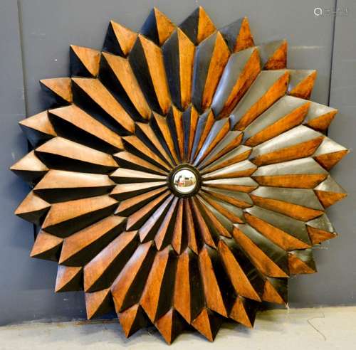 A large wooden hand carved starburst mirror, 102cm by 102cm