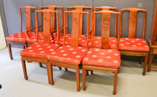 A set of eight Chinese rosewood chairs, including two carvers, and having red silk padded