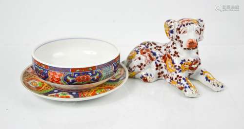 An Imari plate and matching dish together with a Chinese hound, bearing marks to base.
