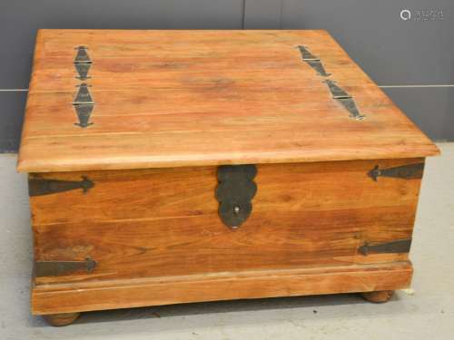 A large Indonesian box / coffee table, clad with iron, 40 by 94 by 96cm.