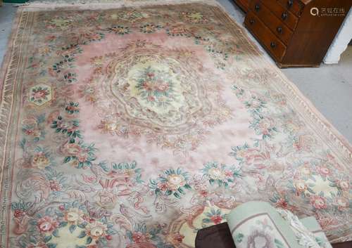 A large modern carpet, floral pattern on a pink ground, 366cm long.