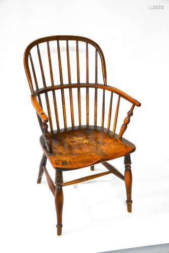 A 19th century Windsor chair, with hoop back, pierced with spindles, the elm seat raised above a H-