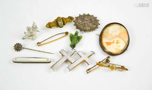 A silver and cameo brooch, three pin brooches, two crucifix pendants, a mother of pearl fruit