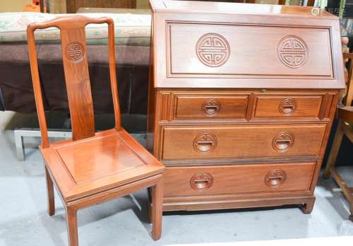 A 20th century Rosewood bureau, with fall front and fitted interior, and carved with emblems,