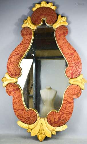 An antique gold painted and fabric lined scroll work wall mirror, 105 by 66cm.
