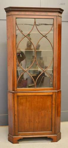 A 19th century glass fronted mahogany corner cupboard, the glazed door bearing curved astrigals