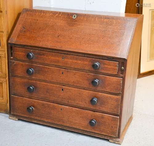 A Victorian oak bureau, with fall front enclosing a fitted interior, with four long graduated