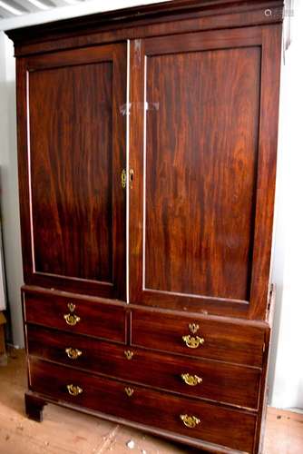 A 19th century Georgian mahogany linen press, with two large cupboard doors, enclosing sliding