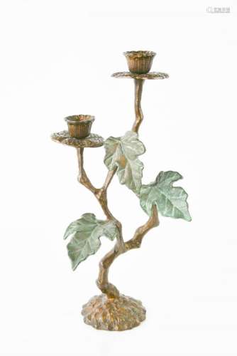 A bronzed candelabra in flower form. 20cms tall x 11cms wide