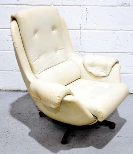 A Parker Knoll style faux leather cream swivel armchair.