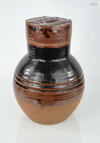 A Studio ware stone glazed bottle and cover, the cover embossed with design. 28.5cm