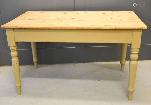 An antique pine kitchen table with painted legs. 74cm by 126cm by 75cm