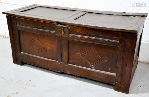 An 18th century oak two plank coffer, with candle box interior and raised on stile feet, 54cm