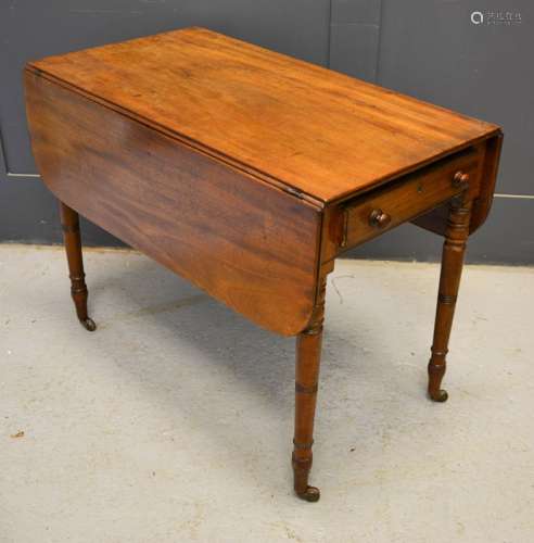 A 19th century mahogany drop leaf table with single drawers turned legs and casters 68cm by 49cm