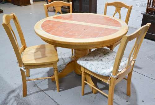 A modern pine kitchen table and chairs, extending, inset with terracotta tiles, with four matching