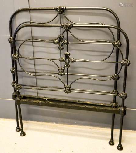 A Victorian black painted cast iron single bed.