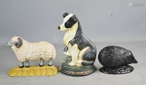 Three cast iron door stops, in the form of a collie dog, sheep and hedgehog.
