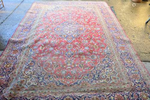 A red ground antique Kashan rug, 250 by 378cm