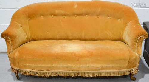 A Victorian button backed velvet settee, with turned feet and castors.