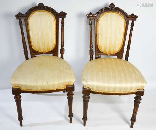 A pair of Edwardian mahogany bedroom chairs, with decorative carved and upholstered back and seats.
