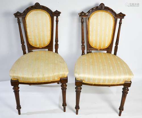 A pair of Edwardian mahogany bedroom chairs, with decorative carved and upholstered back and seats.